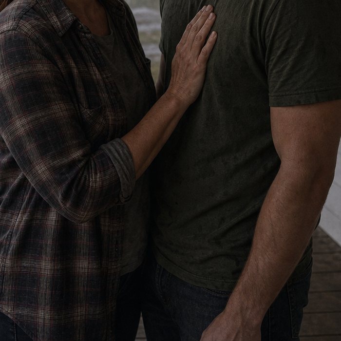 Her hand flat against his chest on a rain-wet porch. Both of them muddy, neither of them moving.